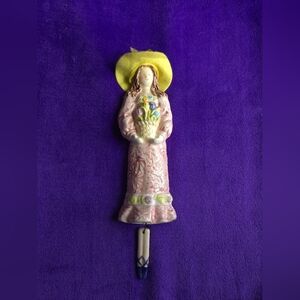 Sweet ceramic wall hanging with dangling legs. This pretty girl dances with flow